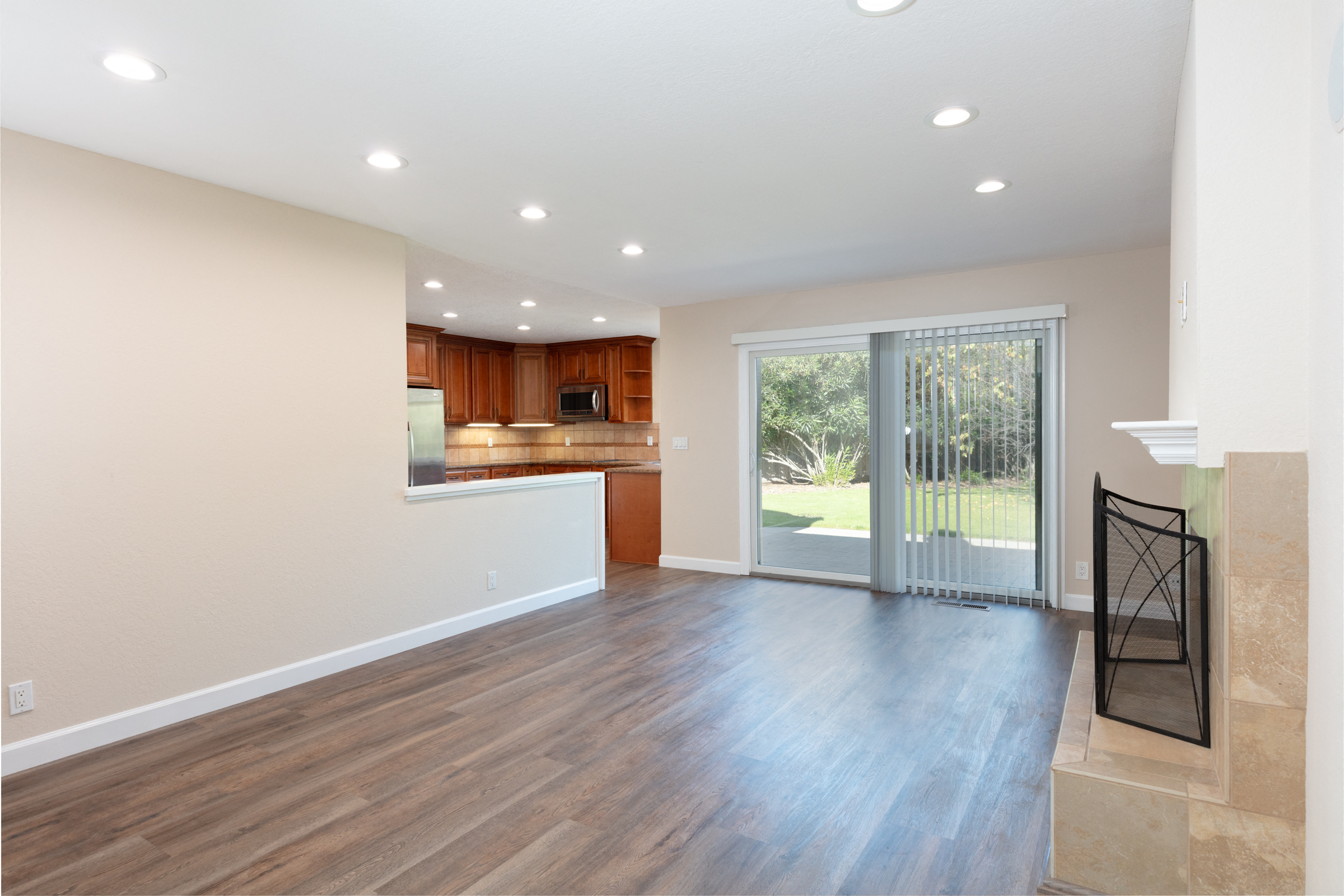 a living room and kitchen with a sliding glass door
