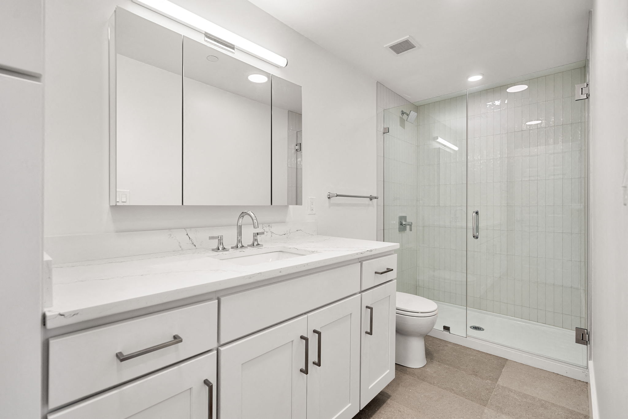 a bathroom with a sink and a toilet and a shower