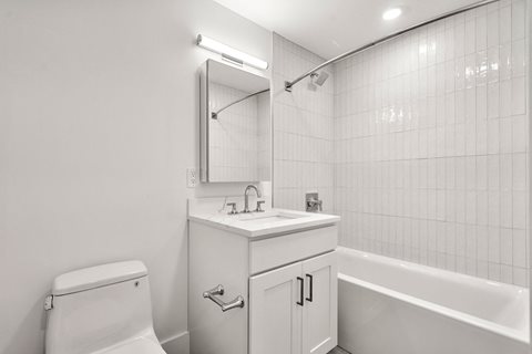 440-7 a bathroom with a sink and a toilet and a bath tub