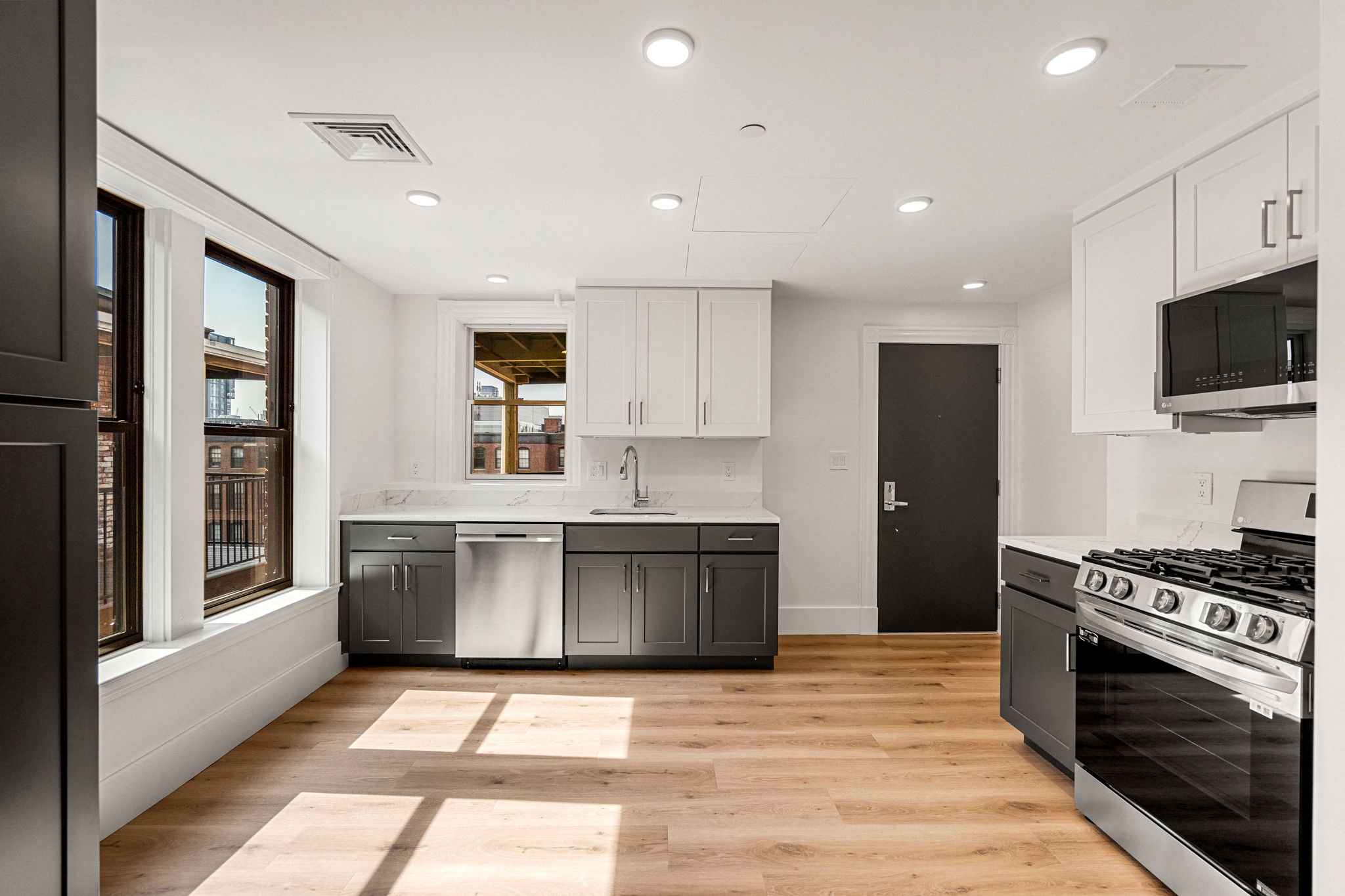 a kitchen with white cabinets and stainless steel appliances