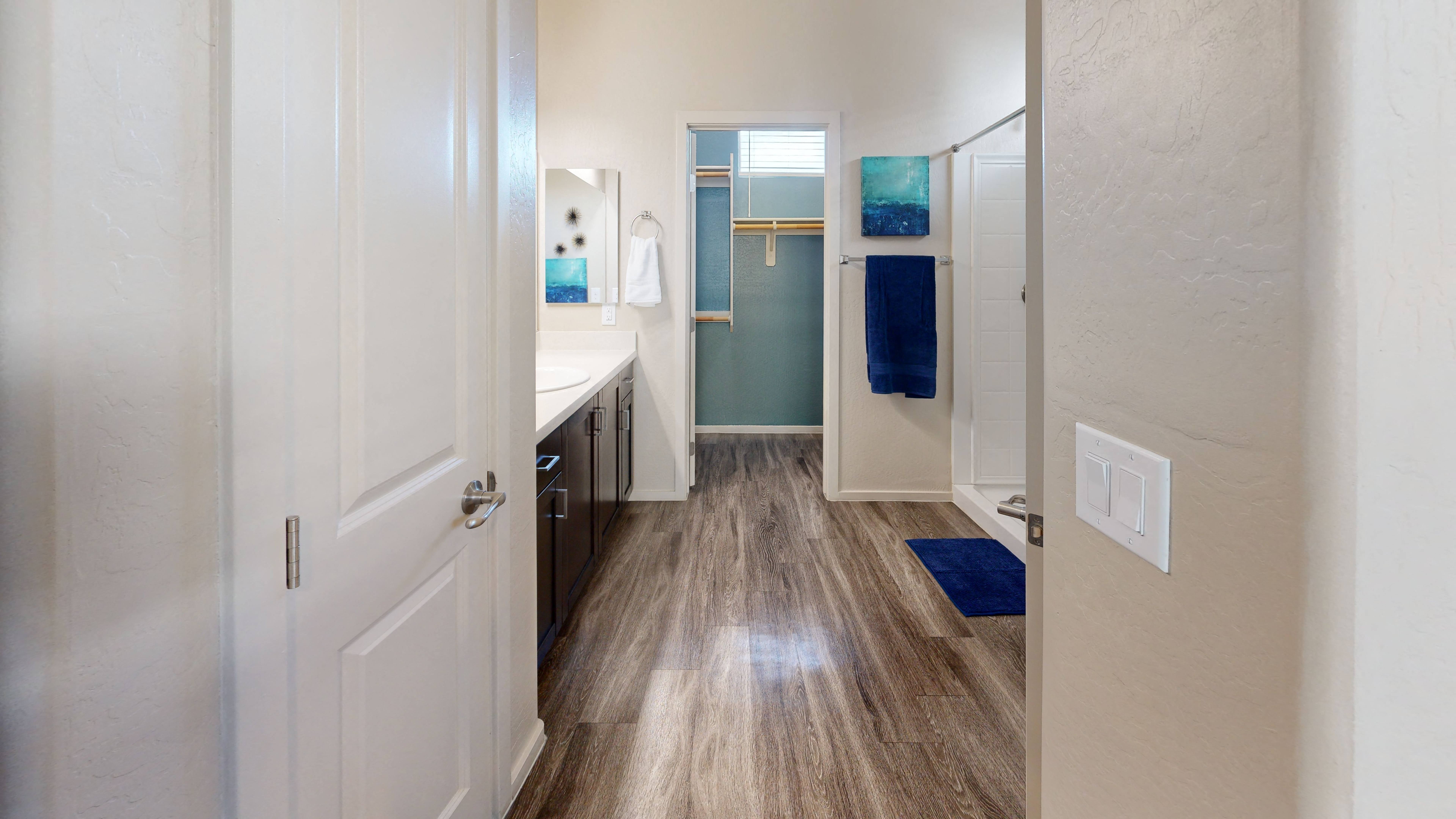 a bathroom with a sink and a mirror at Olive Queen Creek Apartments, Queen Creek, Arizona