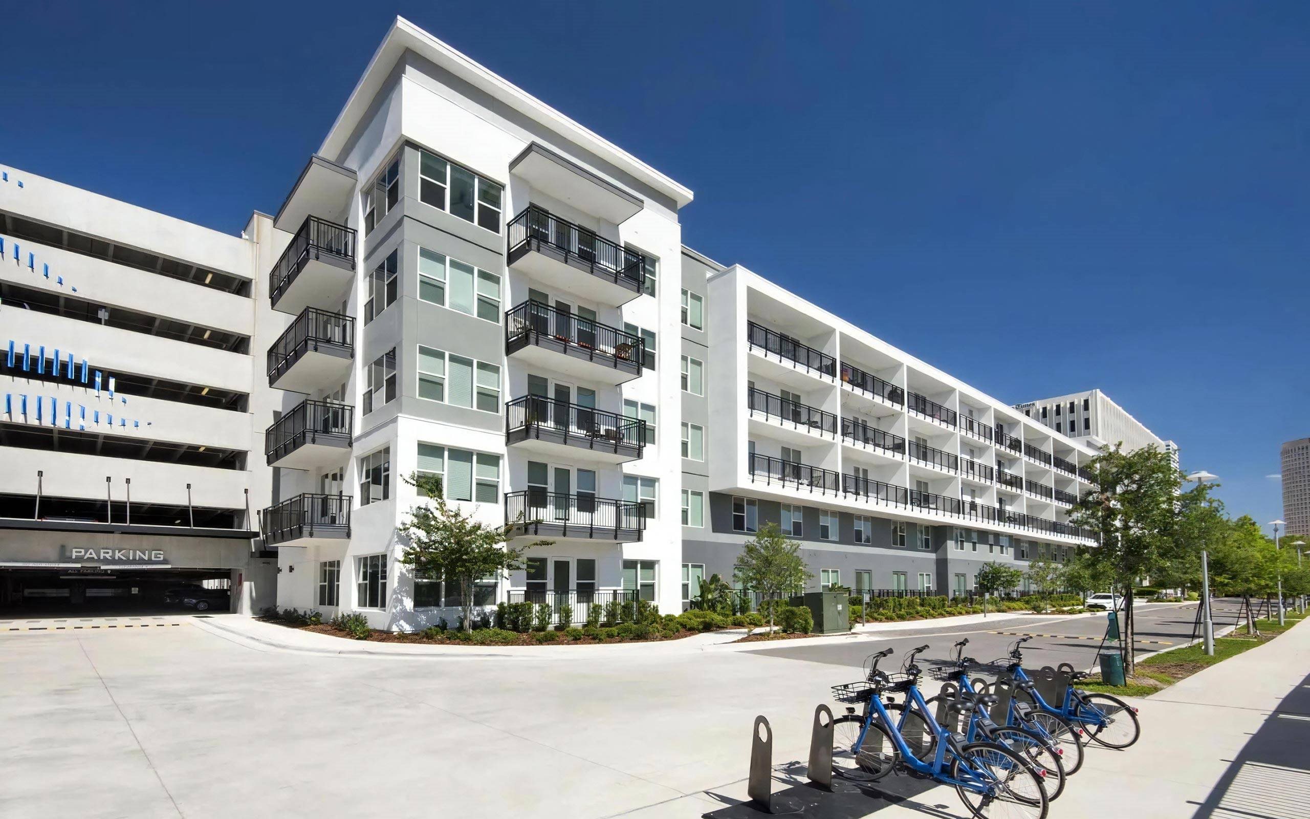 Anchor Riverwalk Community Building with Adjacent Parking Garage and Bike Share Station