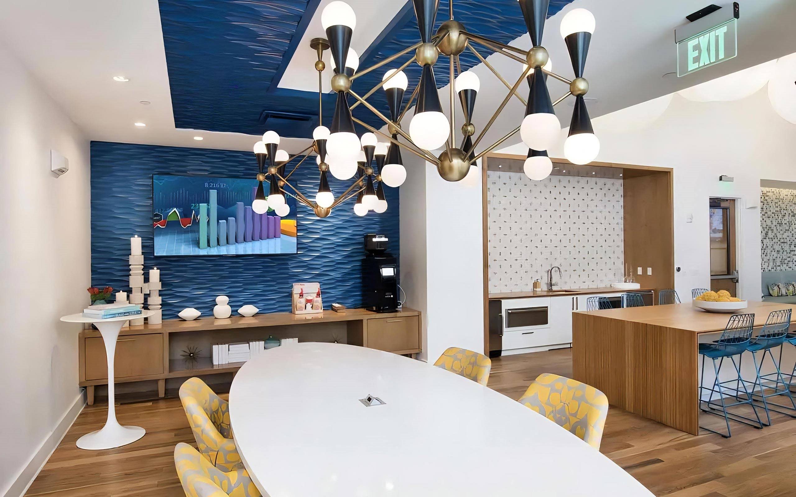 Community Lounge with TV, Coffee Station, and Modern Lighting Fixtures