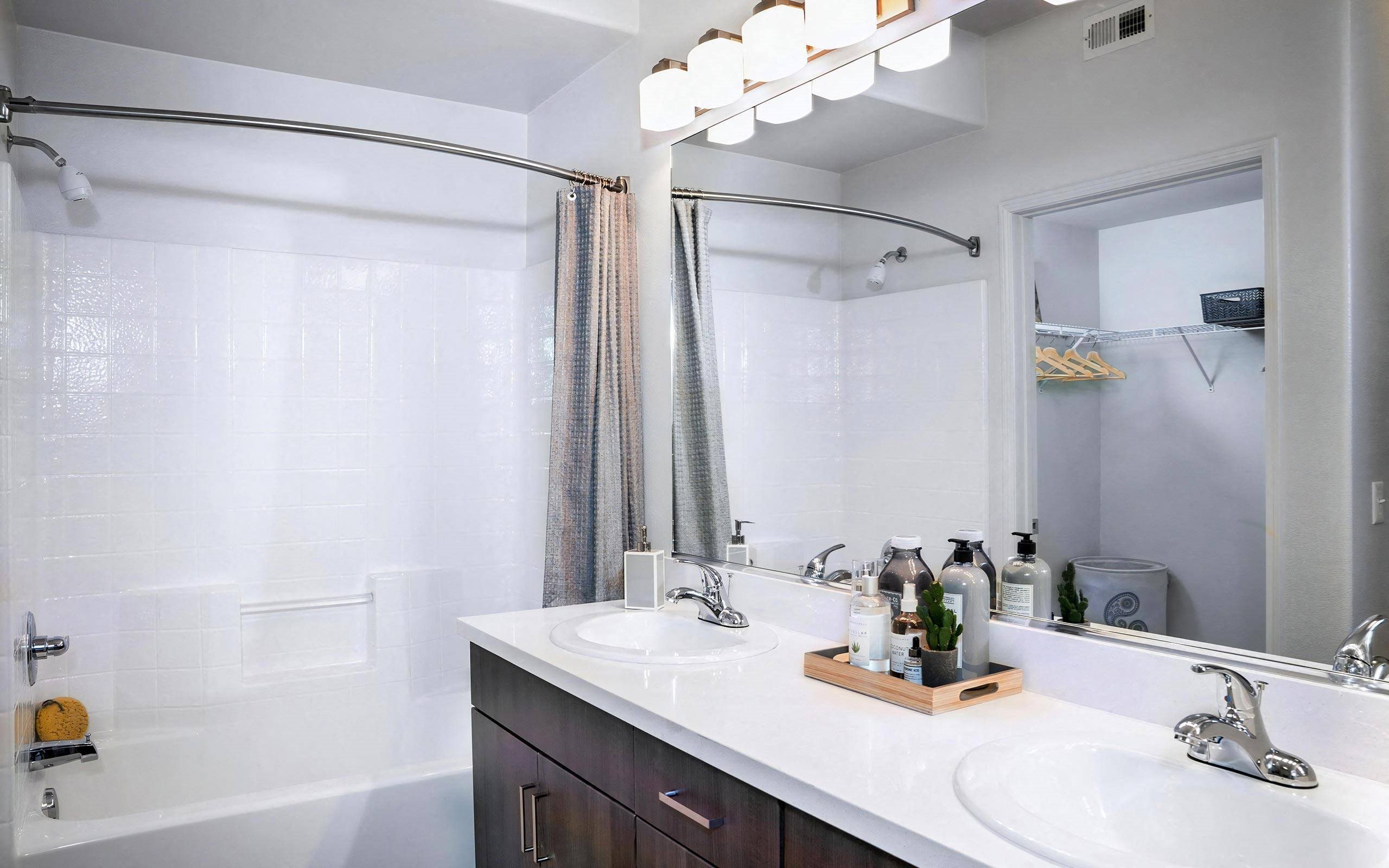 Double Vanity Bathroom with Ample Storage and Contemporary Lighting
