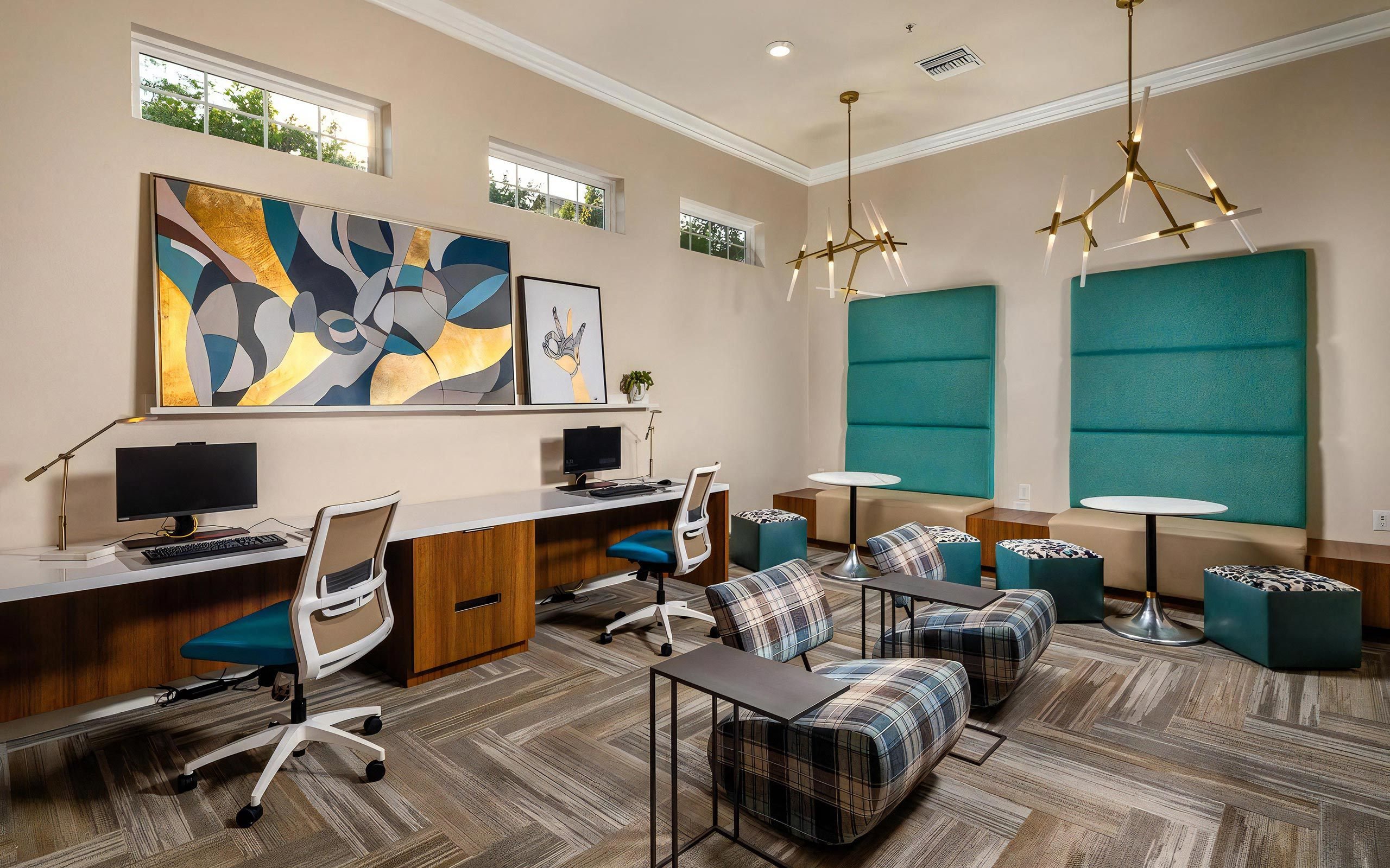 Stylish Resident Lounge Featuring Desks, Lounge Chairs, And Booths