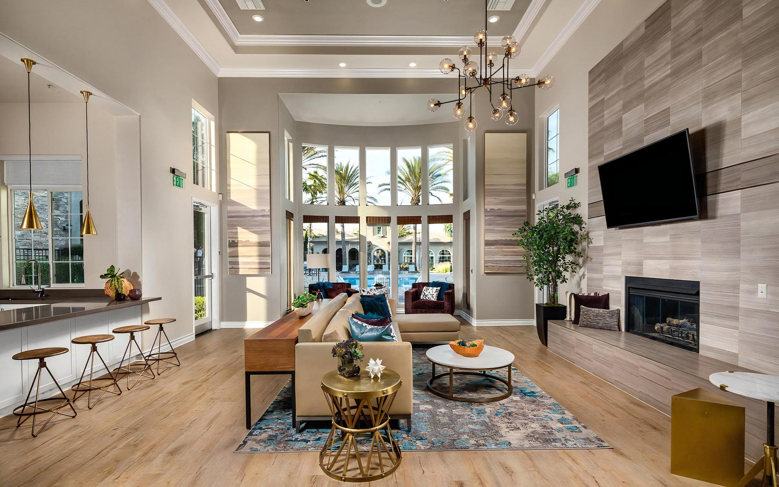 Open-Concept Community Living Area with Tall Windows and Lounge Furniture