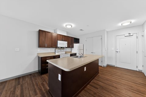 A kitchen with brown cabinets and a countertop.