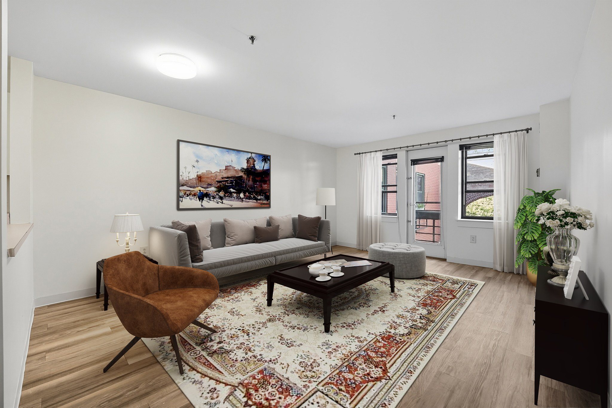 A living room with a brown chair and a grey couch.