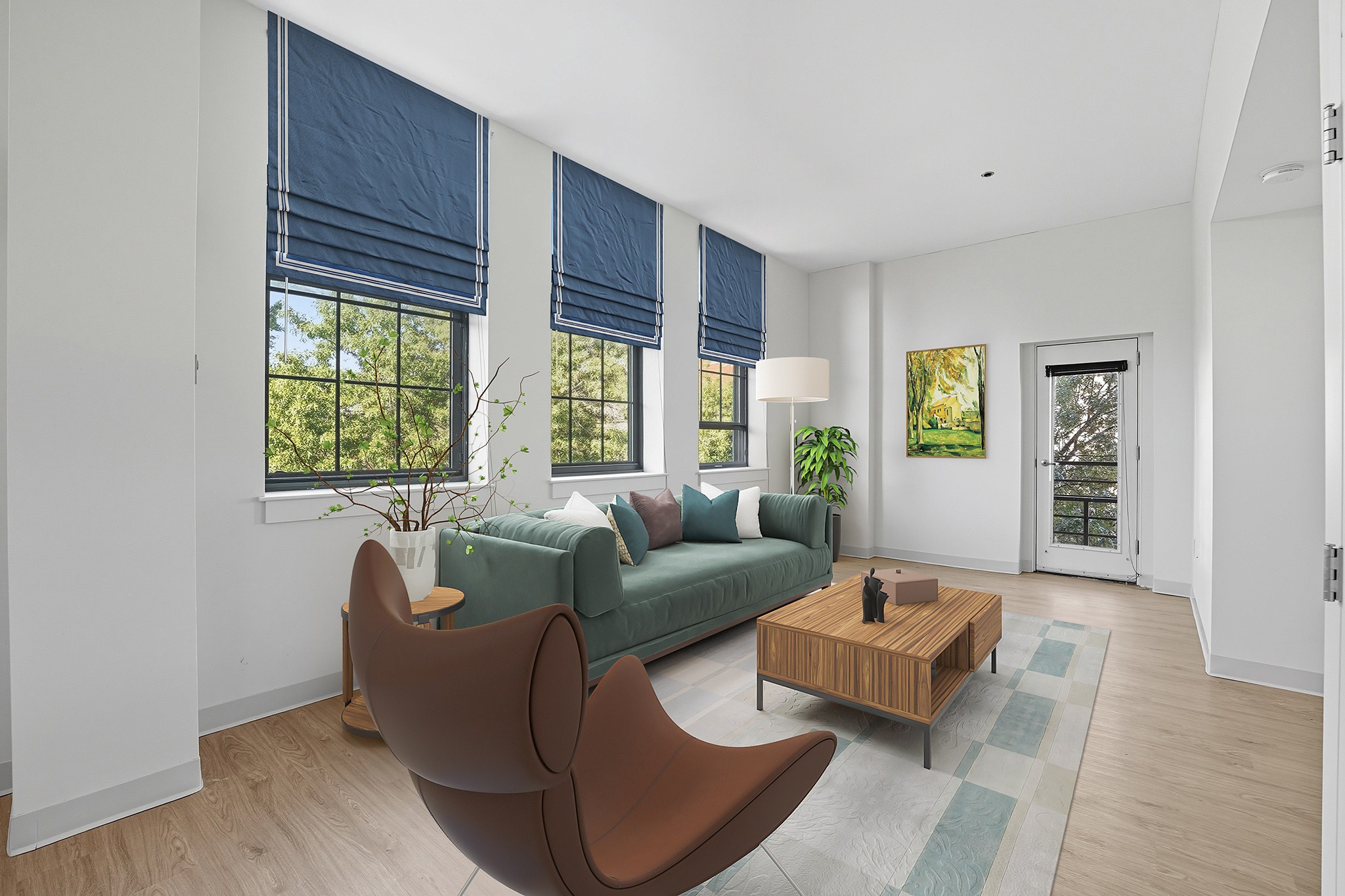 A living room with a green couch, a brown chair, and a wooden coffee table.