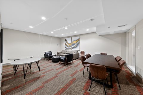 A conference room with a long table and chairs.