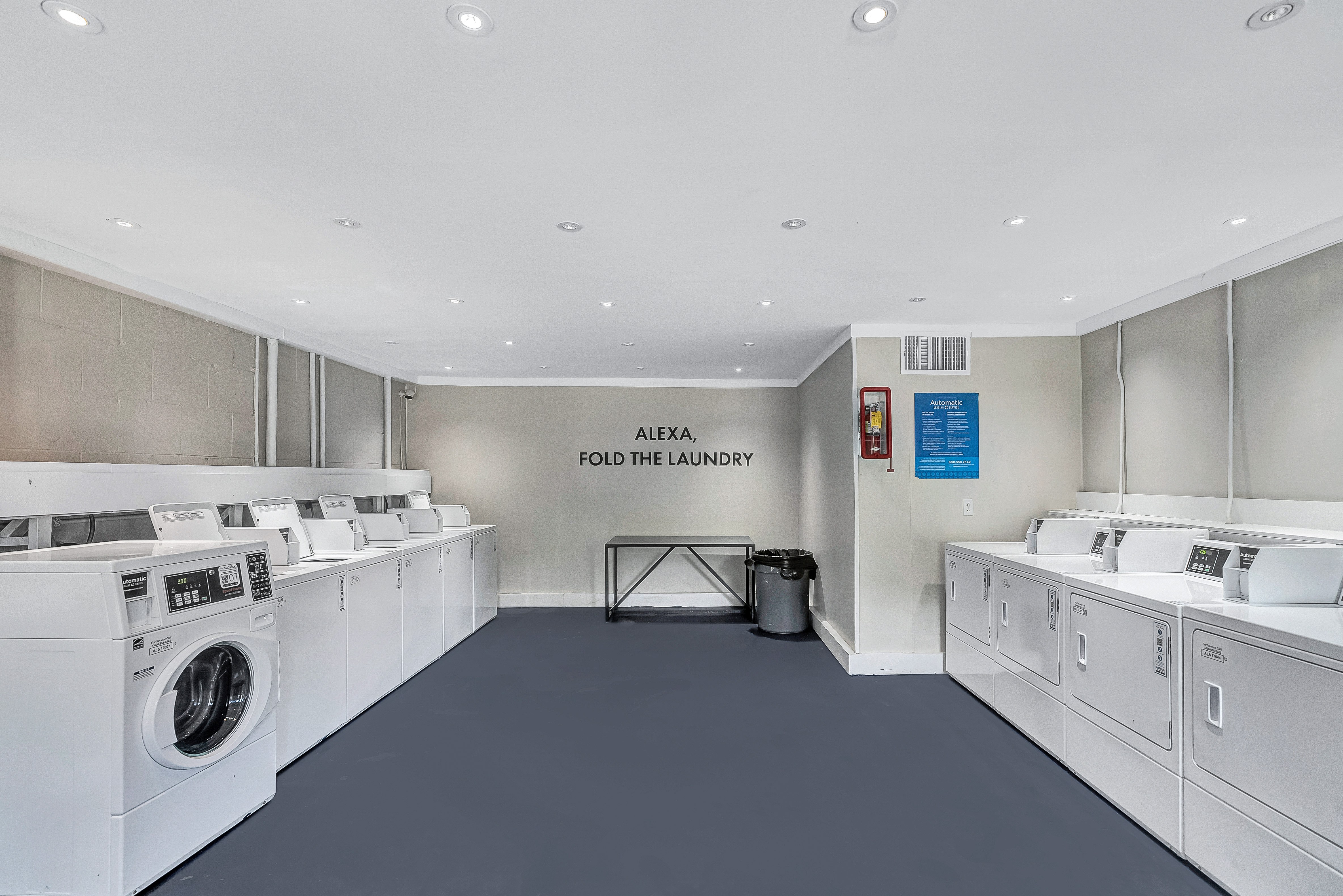 A laundromat with the sign "Alexa Fold the Laundry" on the wall.