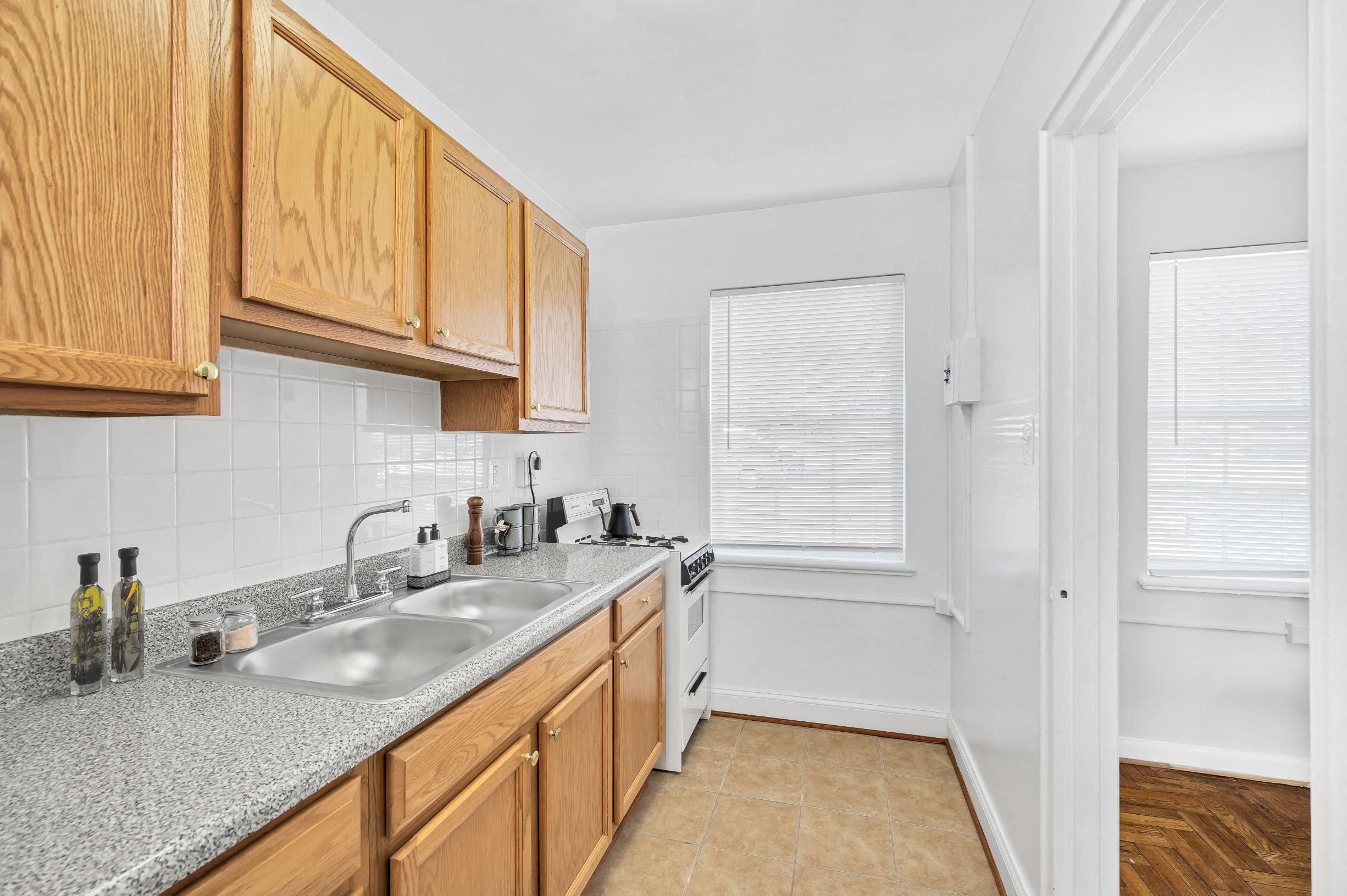 A kitchen with wooden cabinets and a granite countertop.