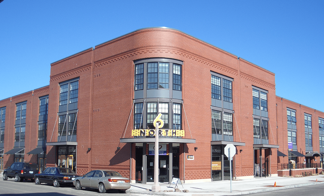 A large brick building with a sign on the from of it.