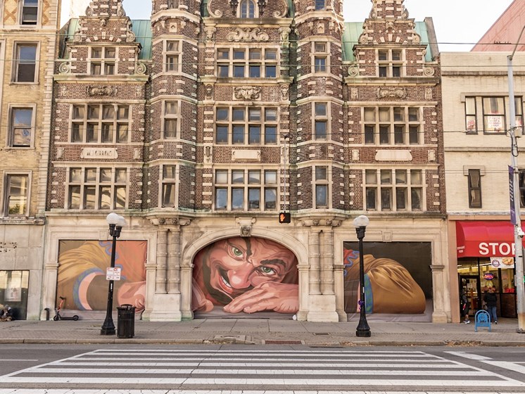 Street view of apartment building with the mural of the giant- The Arts Lofts at Dayton Arcade, Dayton, OH - Kevin Lush Photography