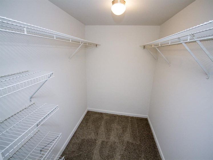 Walk-in closet with rack shelves and carpet floor-Quality Hill Square, Kansas City, MO