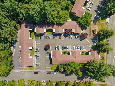 a birds eye view of a house in a parking lot