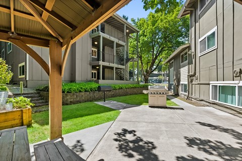 our apartments have a spacious patio with a picnic table and a fire pit