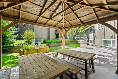a covered patio with picnic tables