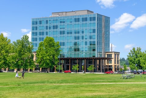 a large glass building on top of a green field