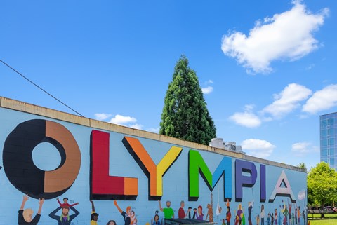 a mural on the side of a building with the word olympia on it