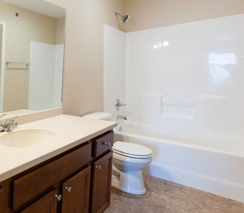 Bathroom with white tub, toilet and bath vanity