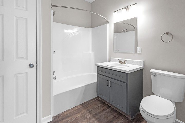 A white toilet sits next to a sink in a bathroom.