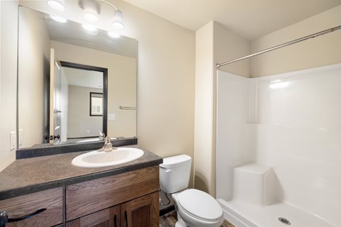 A bathroom with a sink, toilet, and bathtub.