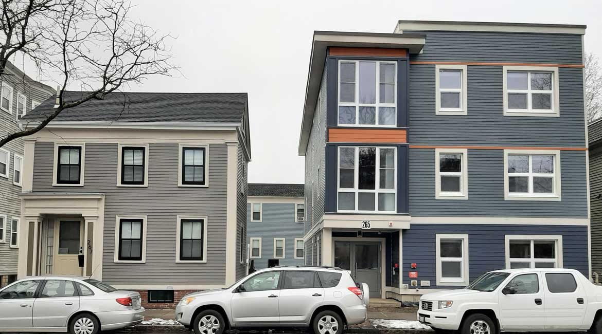 Newly completed construction shows two new buildings that are modern and elegant, fitting nicely into the neighborhood.
