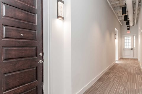 Hallway with high ceilings and exposed loft features