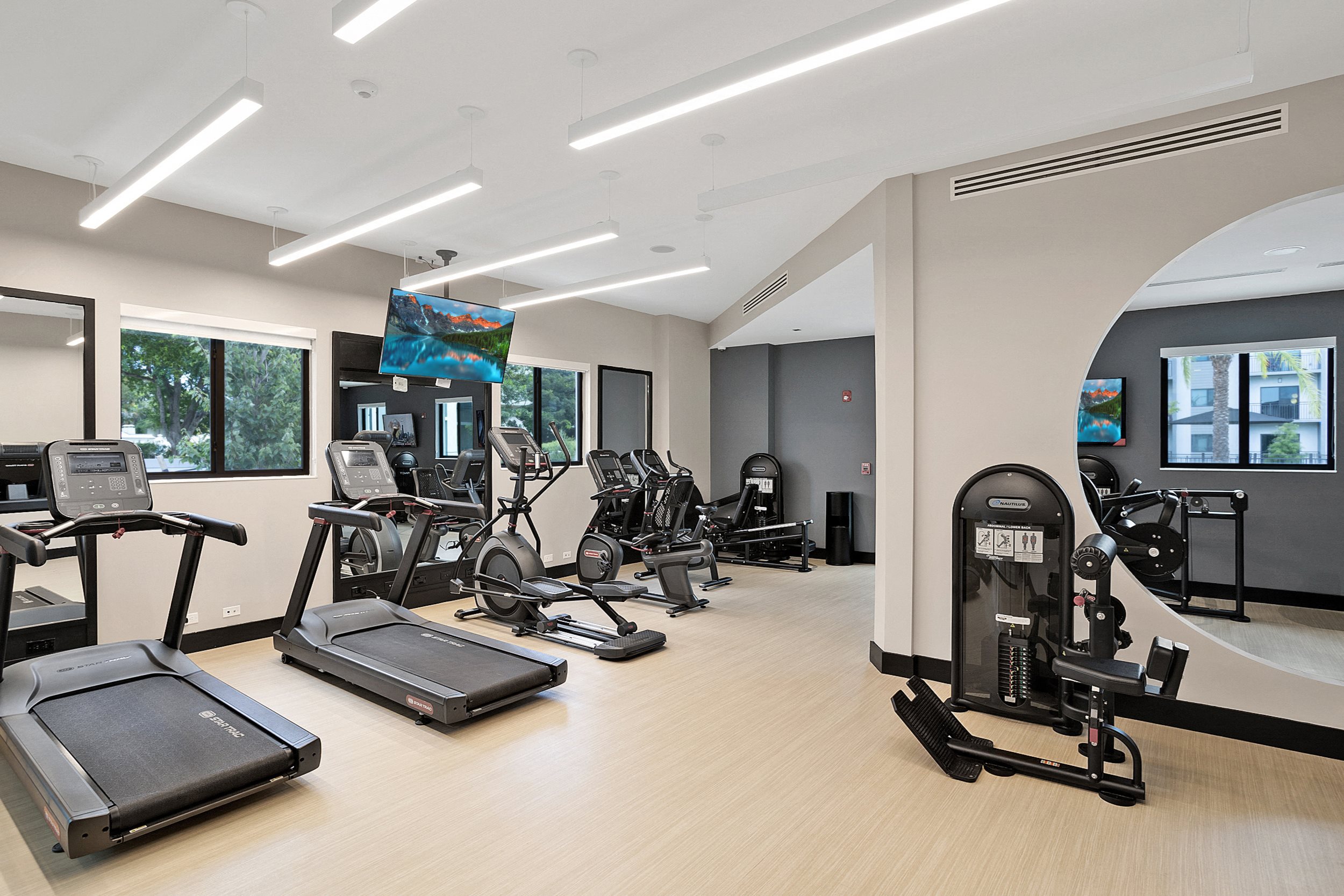 an image of a gym with cardio machines and weights