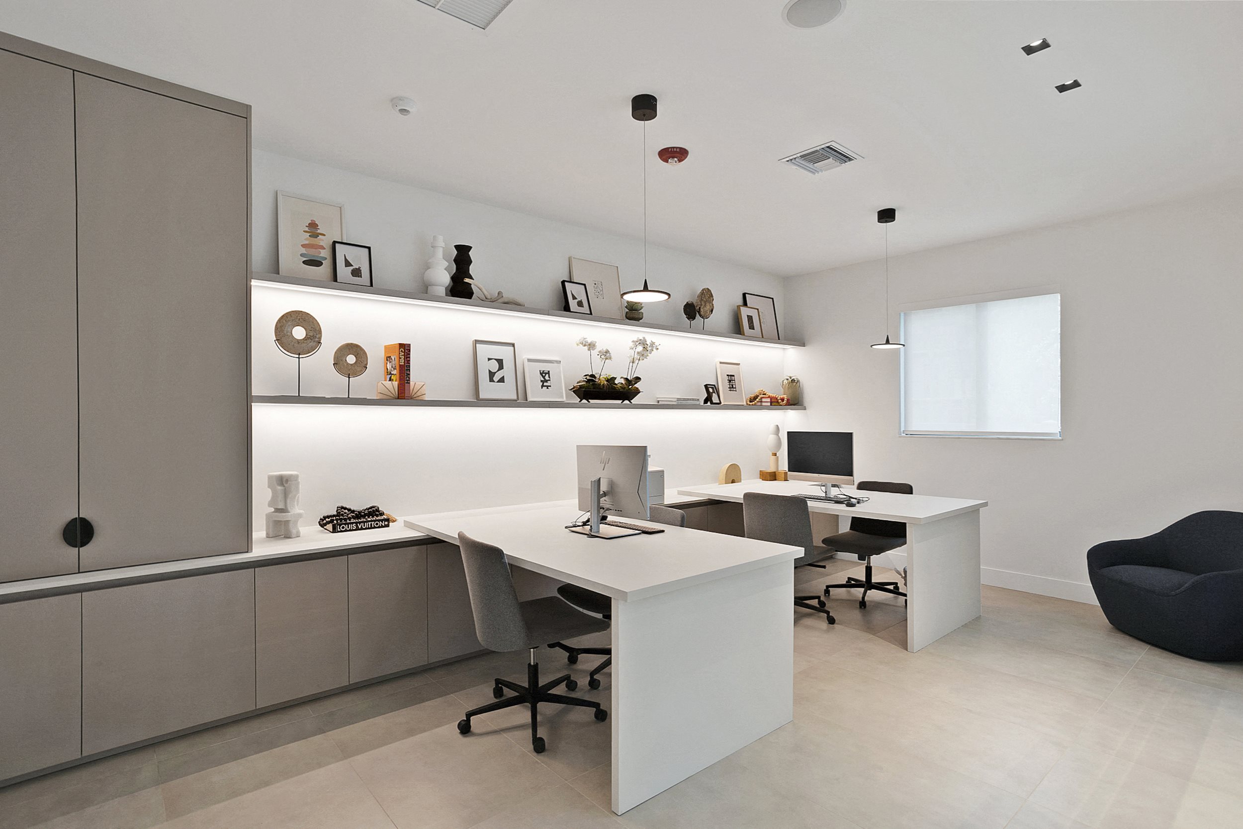 a home office with two desks and a chair