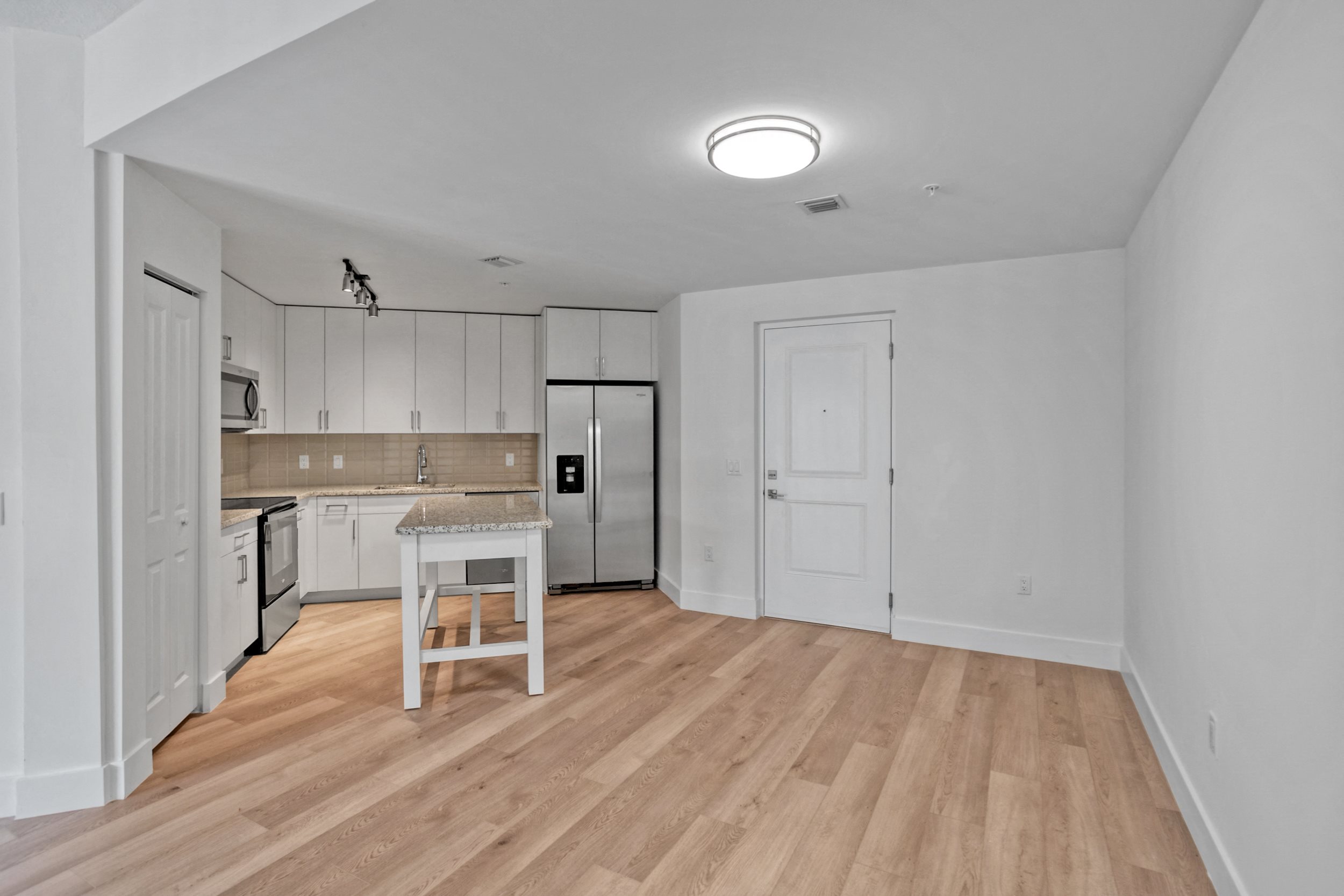 a kitchen and living room in a 555 waverly unit