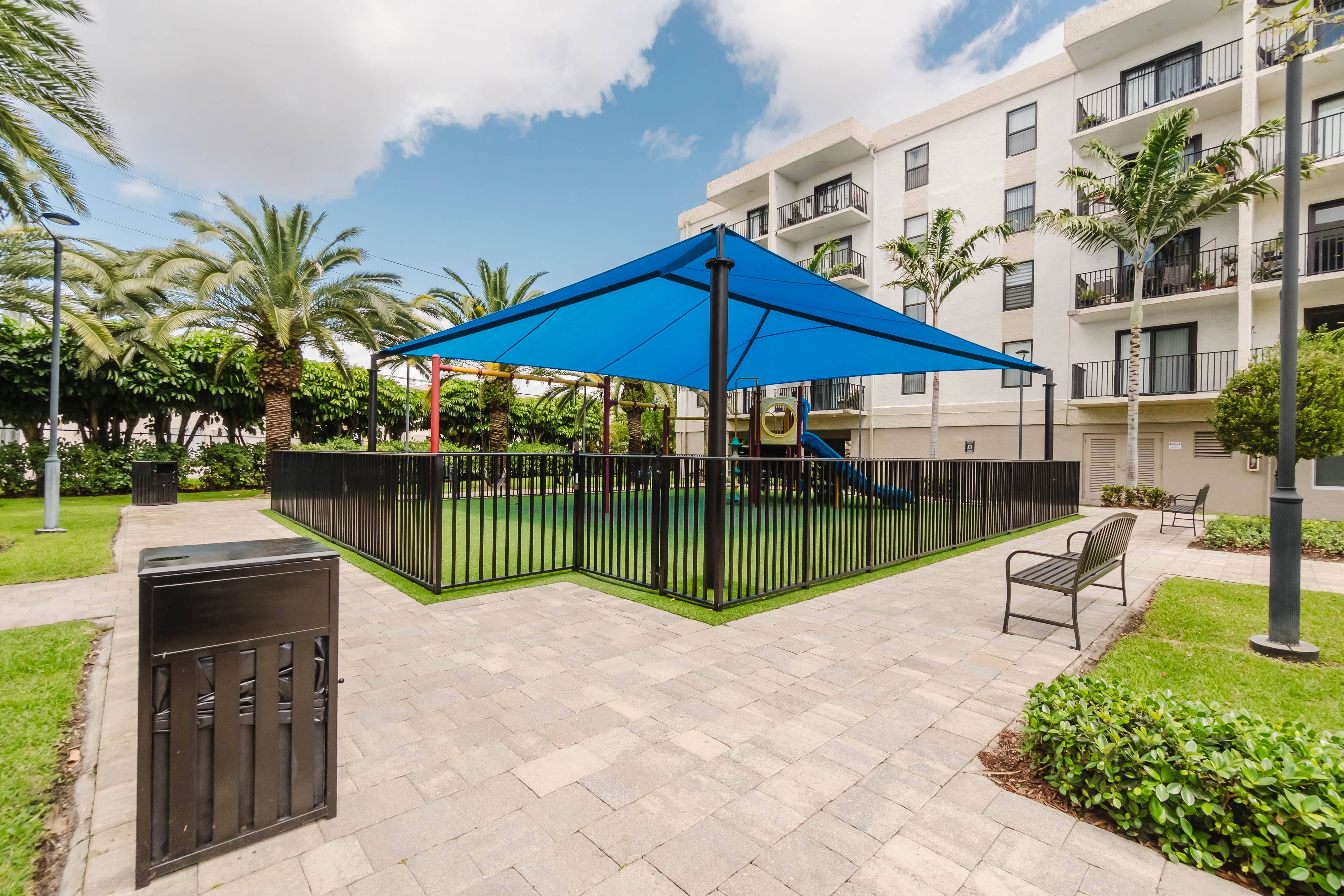 A blue canopy is over a black fence.