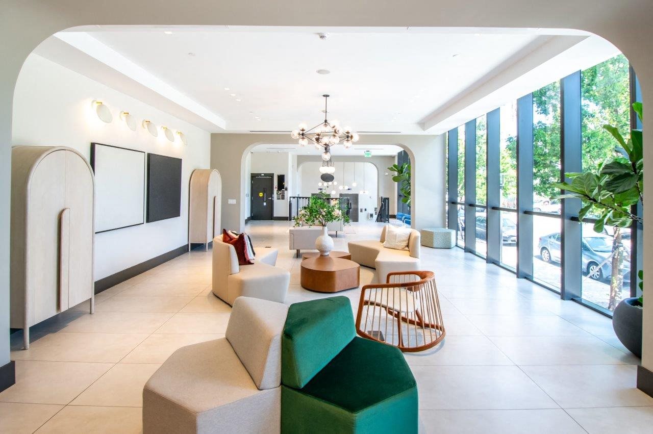 the lobby of a hotel with couches and chairs