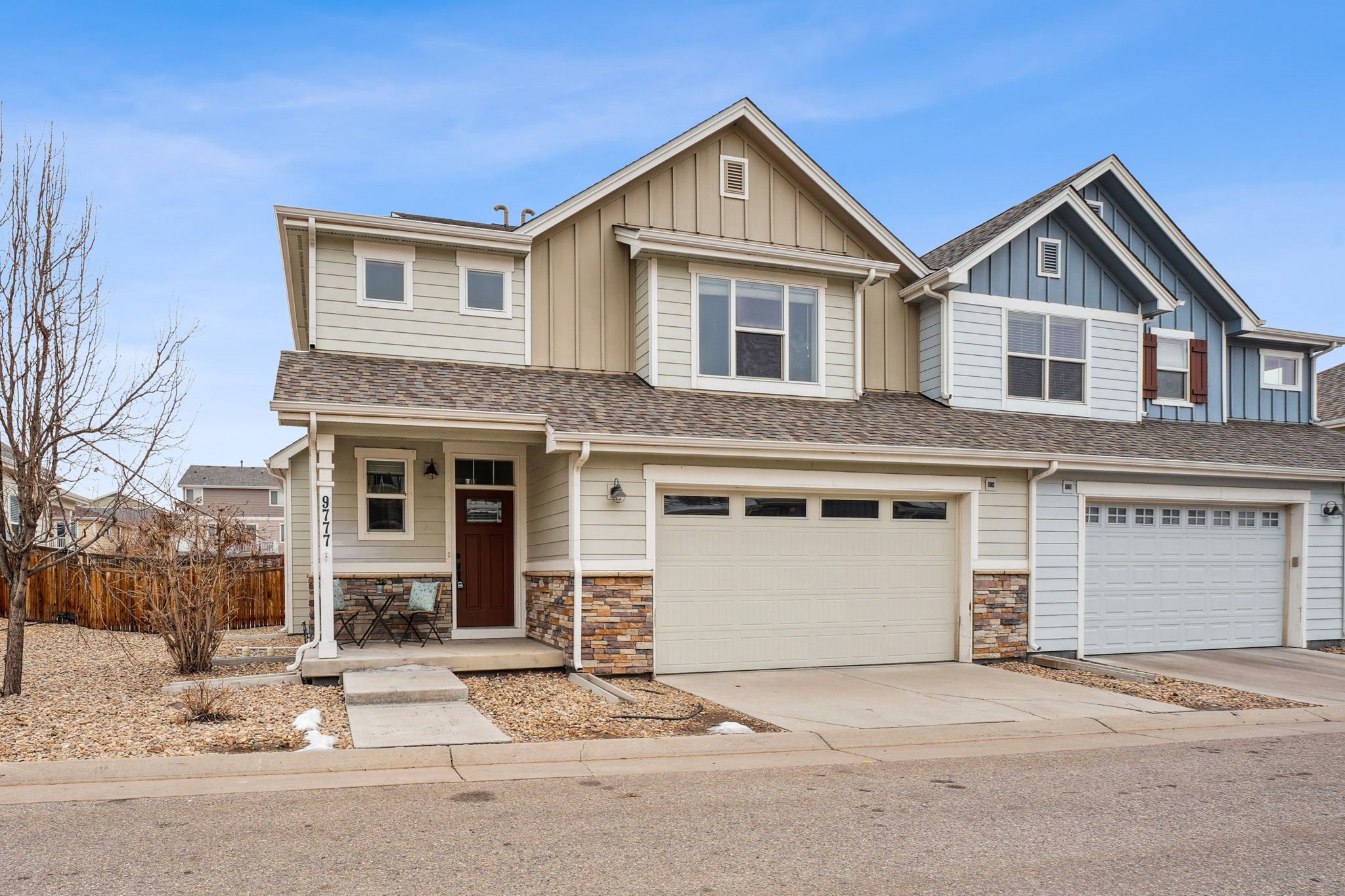 A two-story house with a garage is shown in the image.