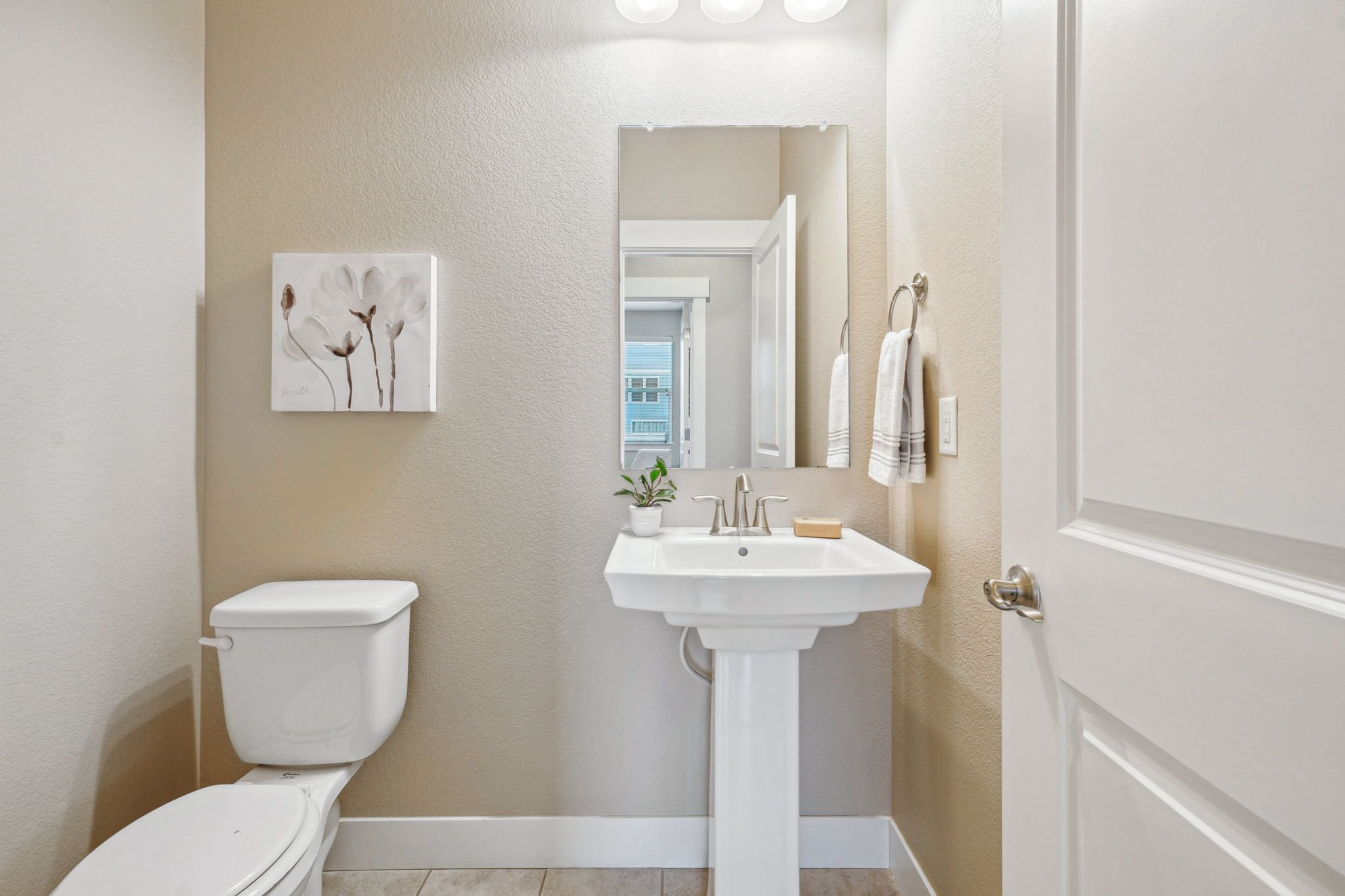 A white toilet and sink in a small bathroom.
