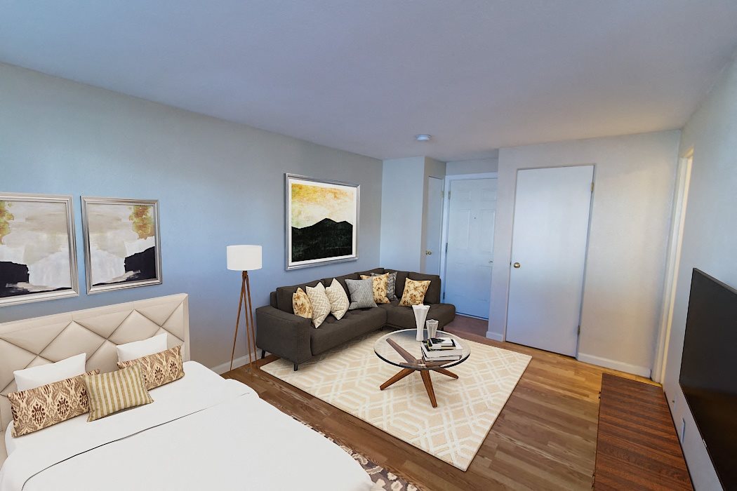 A bedroom with a large bed and a couch.