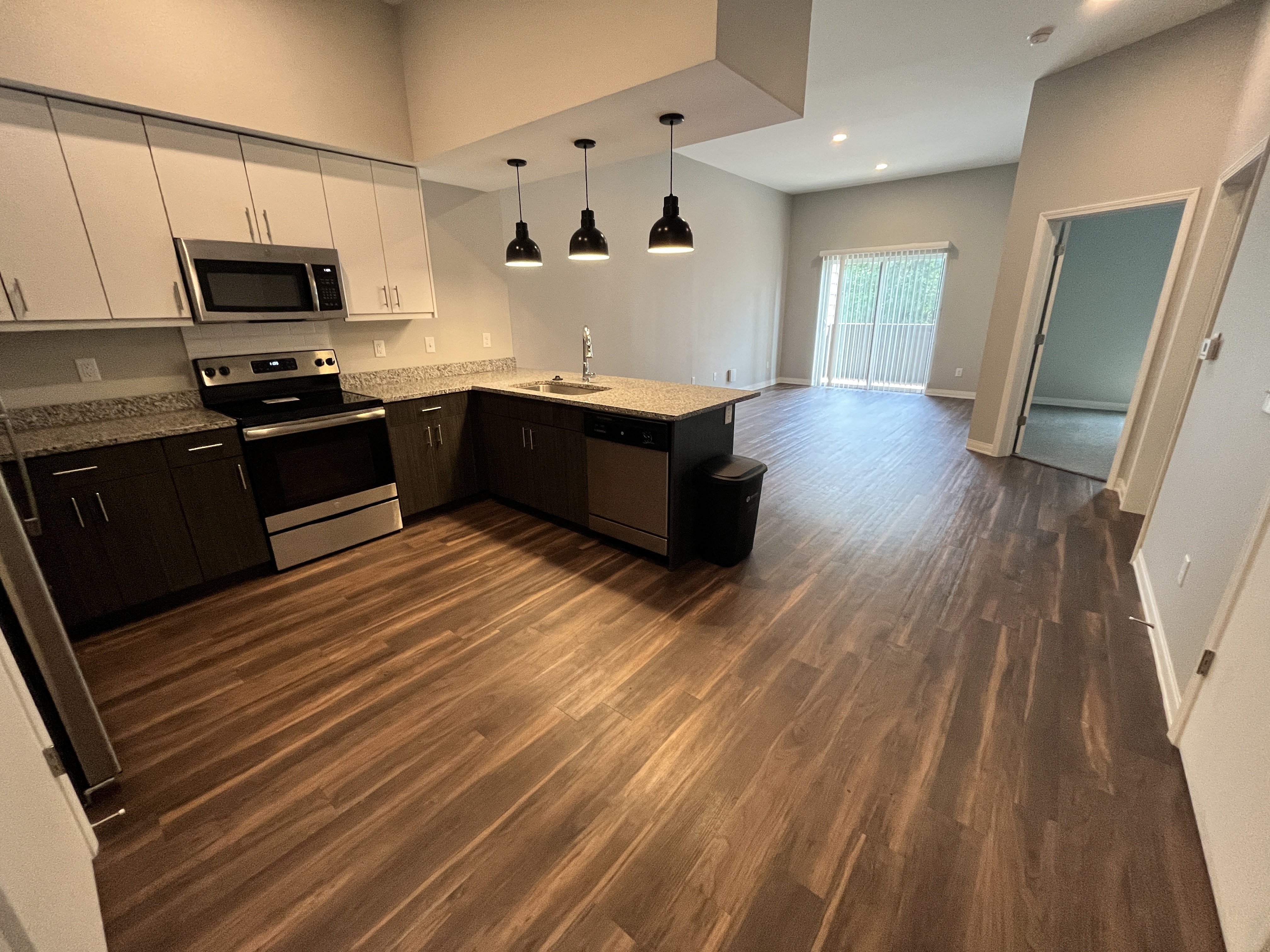 a kitchen and living room with hardwood floors