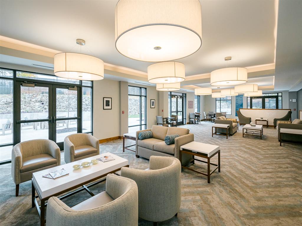 a large room with couches chairs and tables