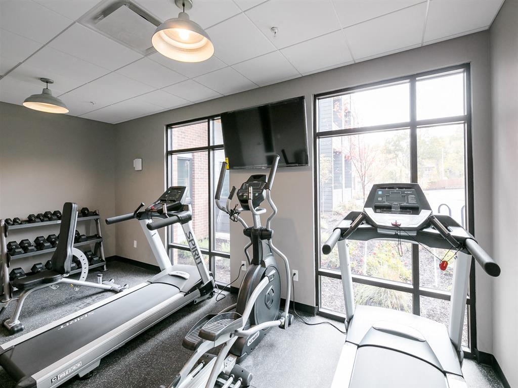 a gym with two treadmills and a treadmill