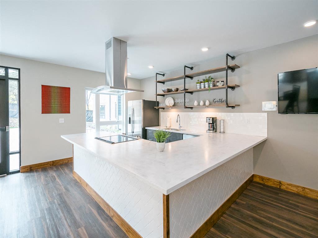 a kitchen with a large white counter top