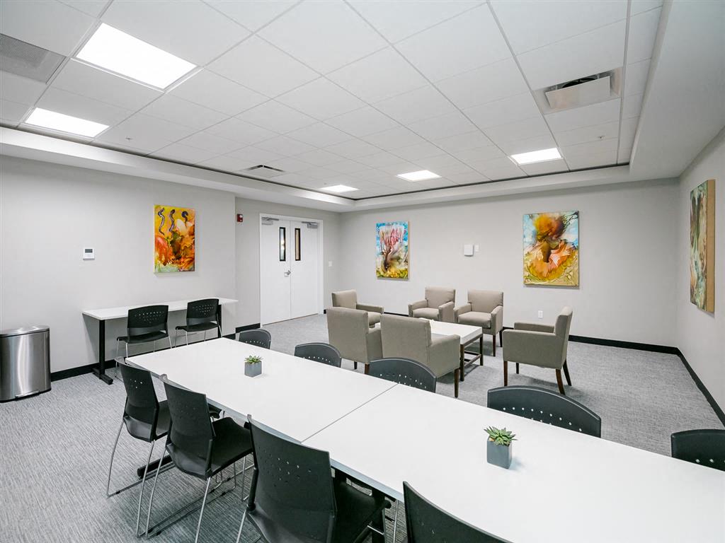 a small conference room with tables and chairs