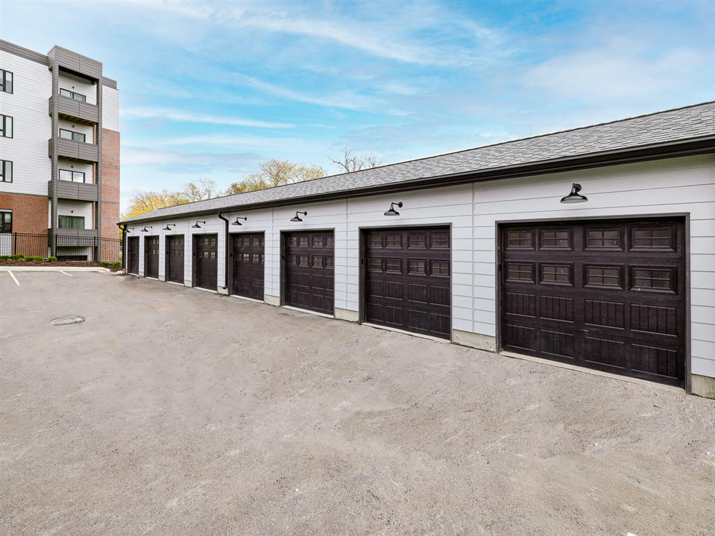 a row of garages in front of an apartment building
