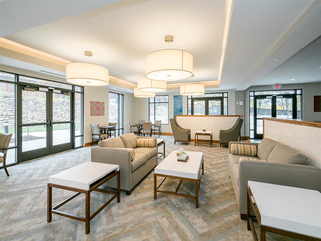 a living room filled with furniture and a large window