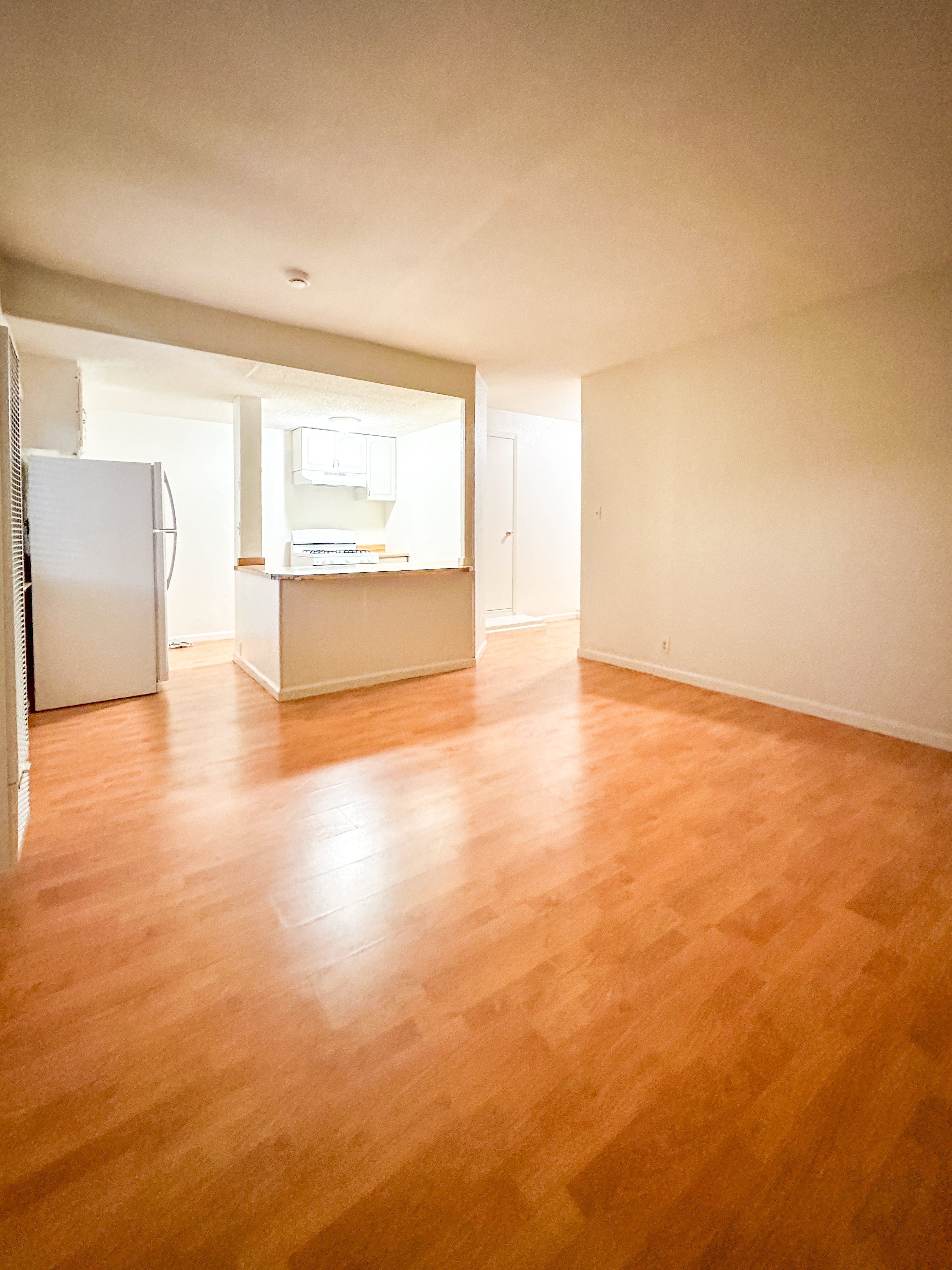 A room with wooden floors and white walls.