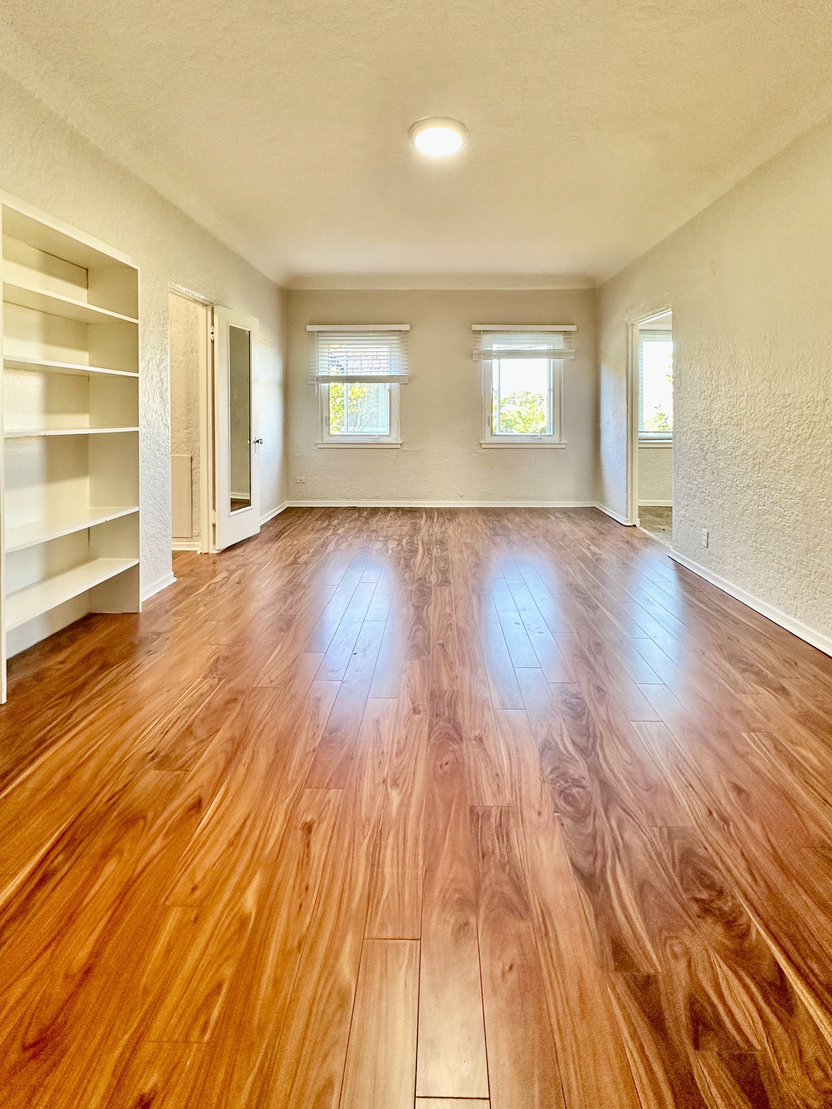 A room with wooden floors and white walls.
