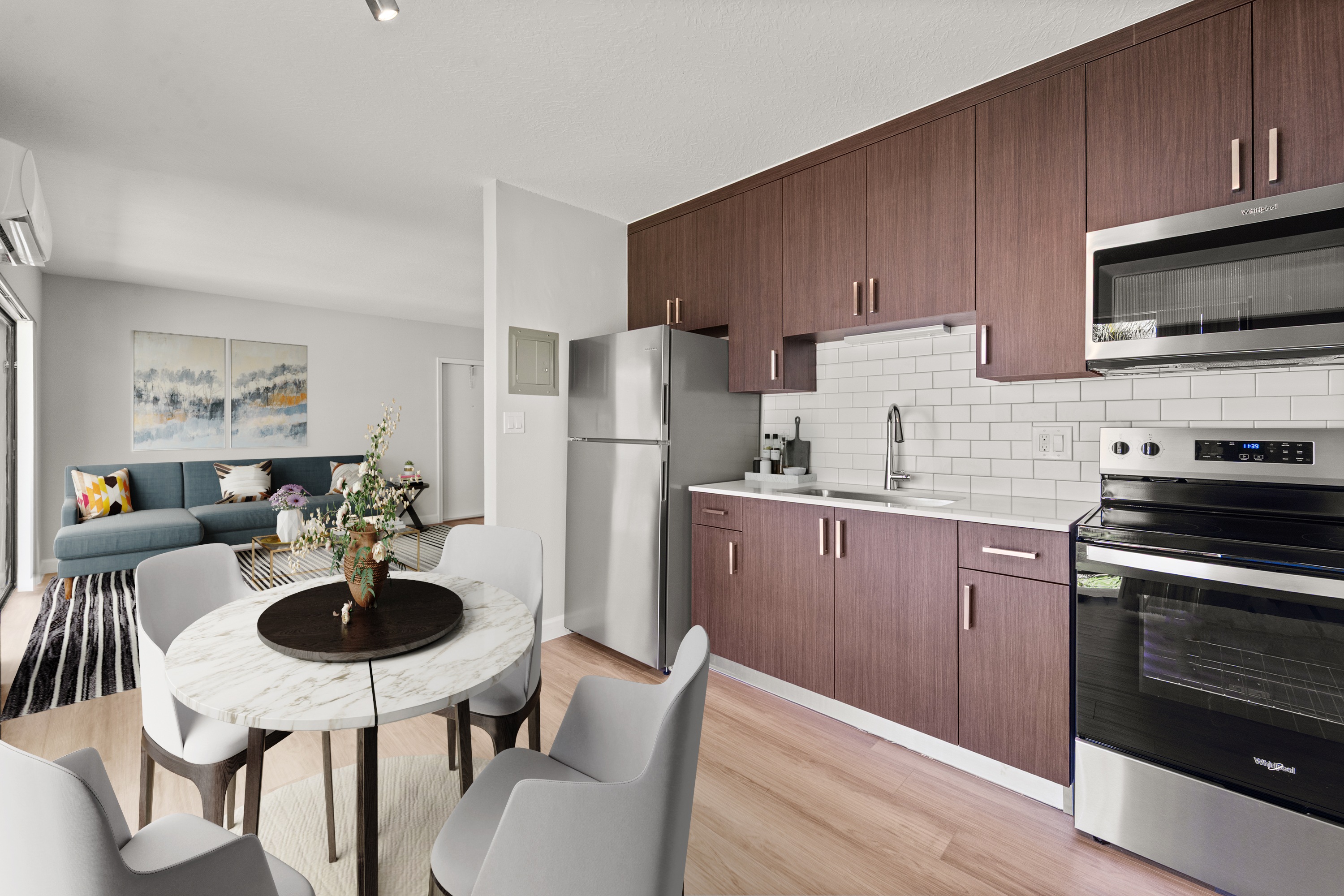 A modern kitchen with a dining table and chairs.