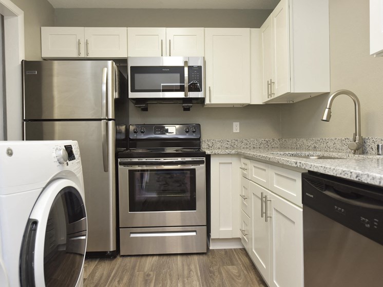 1 BR Apartments in Vestavia Hills, AL - MarQ Vestavia - Kitchen with Stainless Steel Appliances, Granite Countertops, and Hardwood-Style Flooring