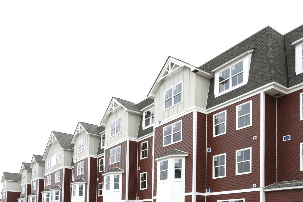 a row of apartment buildings with roofs