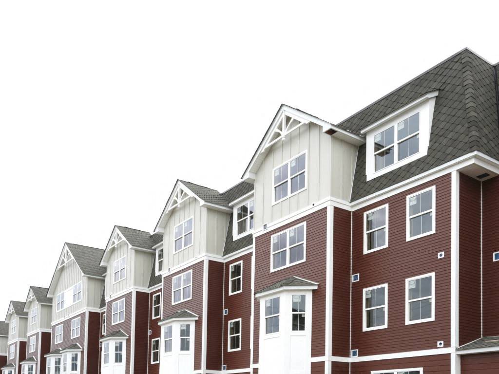 a row of apartment buildings with roofs